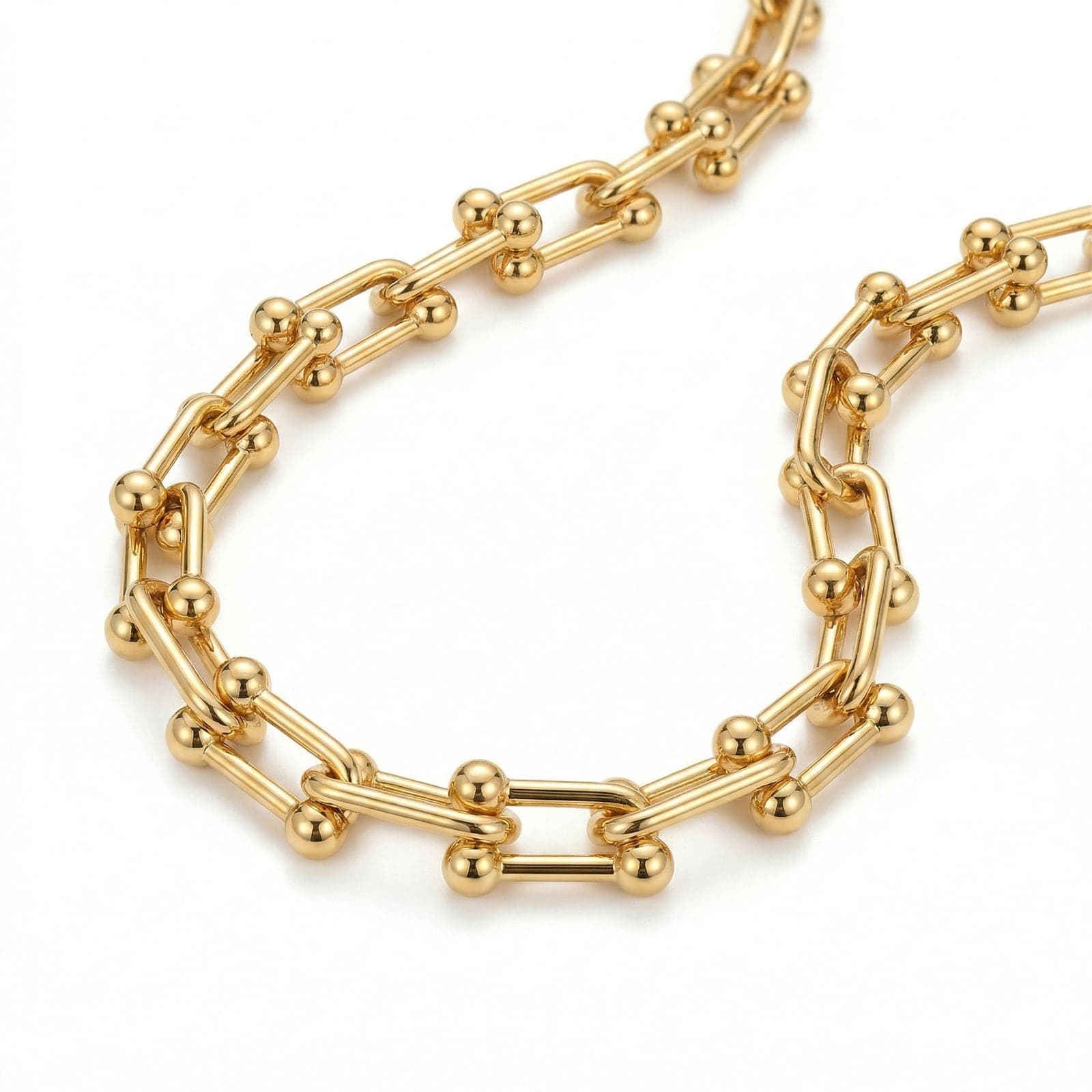 Gold tone chain necklace over brass