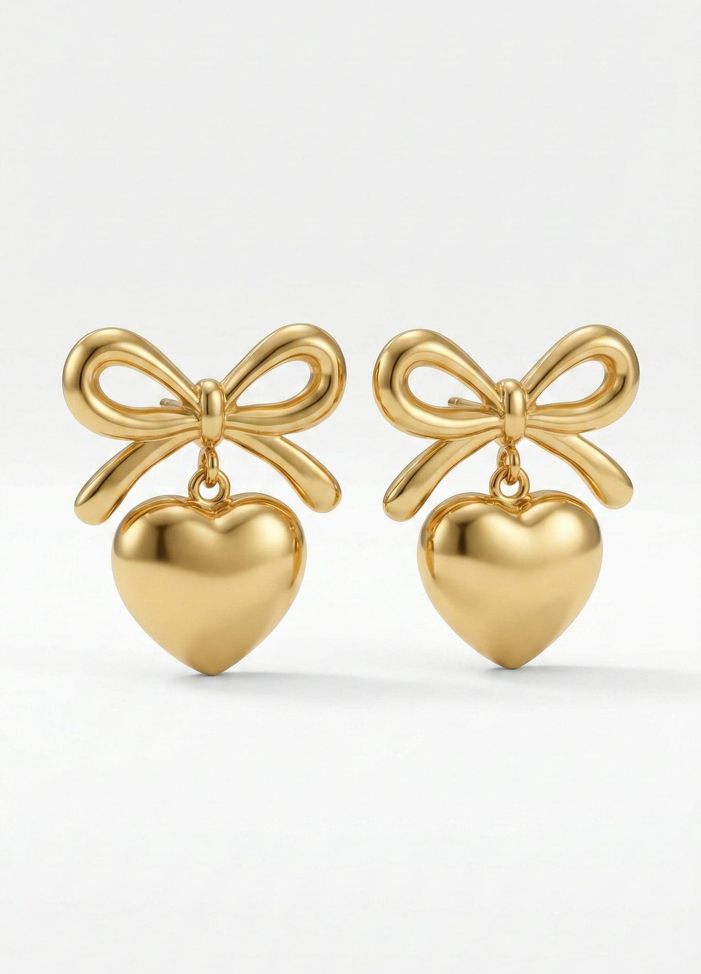 Gold-Plated Brass Earrings with Heart-Shaped Dangle Bow Detail